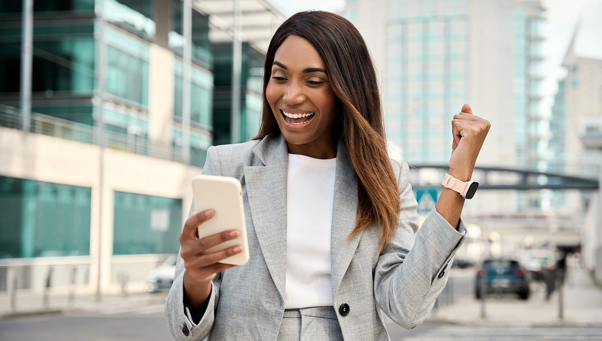 woman holding cell phone cheering